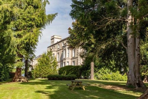 a picnic table in the grass in front of a building at The Waverley Castle Hotel in Melrose