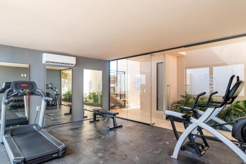 a gym with two tread machines and a mirror at Kaab South Beach by The Spot Rentals in Playa del Carmen