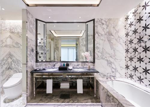 Hotel Okura Manila - Staycation Approved في مانيلا: حمام مع حوض ومرحاض ومغسلة