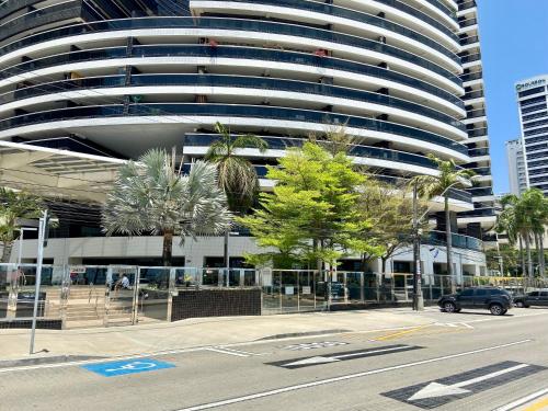 a parking lot in front of a large building at LANDSCAPE SOLAR - Beira Mar de Fortaleza in Fortaleza