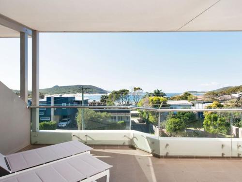 an empty balcony with a view of the ocean at Barefoot Bliss 4, 6-10 Market Street - Surfside Apartments in Fingal Bay