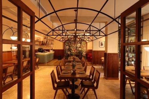 a dining room with a long table and a chandelier at Yangshuo Lisa Boutique Hotel in Yangshuo
