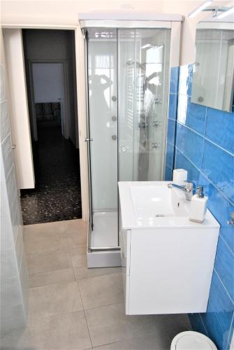 a bathroom with a shower and a white sink at ORIZZONTE SUL MARE in Savona