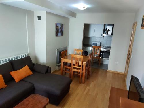 a living room with a couch and a table at Apartamento Morlans Panticosa in Panticosa