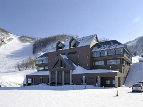 a large building on top of a snow covered mountain at Choine Hotel Sapporo Teine in Sapporo