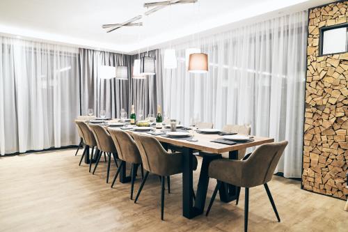 a long dining room with a long table and chairs at Chalet Amadeus in Piesendorf