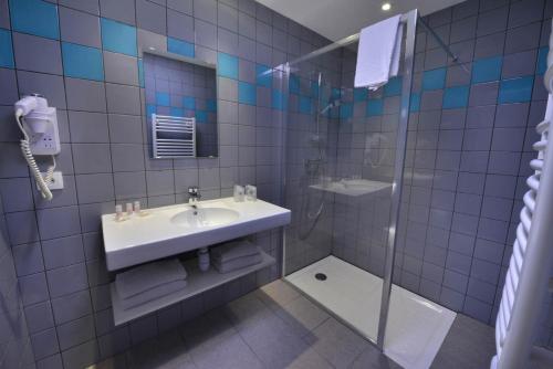 a bathroom with a sink and a shower at Hotel du Val Vert in Pouilly-en-Auxois