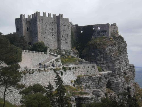 a castle sitting on top of a mountain at History Hotel in Valderice