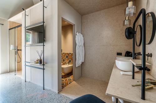 a bathroom with a tub and a sink and a mirror at Laqua Countryside in Vico Equense