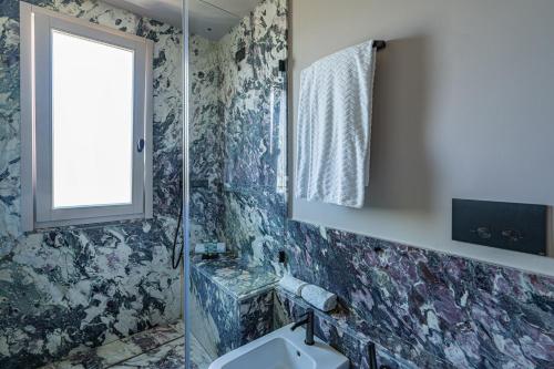 a bathroom with a sink and a window at Laqua Countryside in Vico Equense