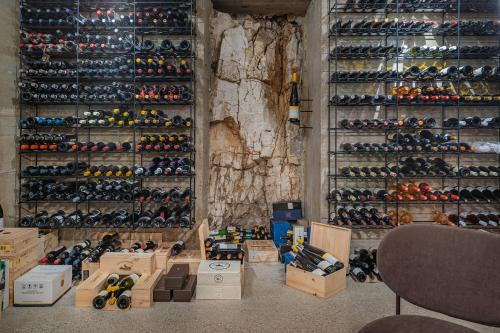 a room with a wall full of wine bottles at Laqua Countryside in Vico Equense