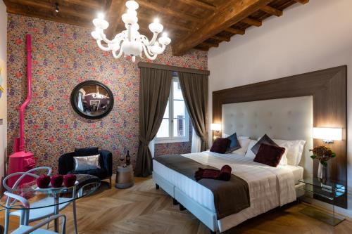 Un dormitorio con una cama grande y una lámpara de araña. en Kairos by Florence Art Apartments, en Florencia