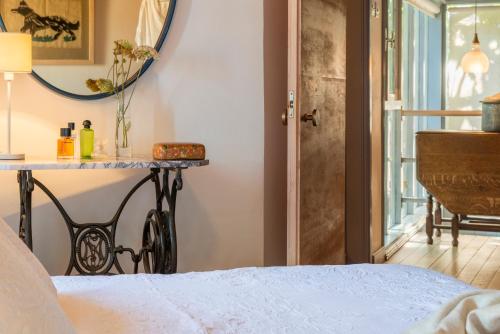 a bedroom with a bed and a table and a window at Ample Places in Pano Lefkara