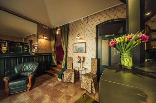 a lobby with a vase of flowers on a table at Hotel Czechia in Prague