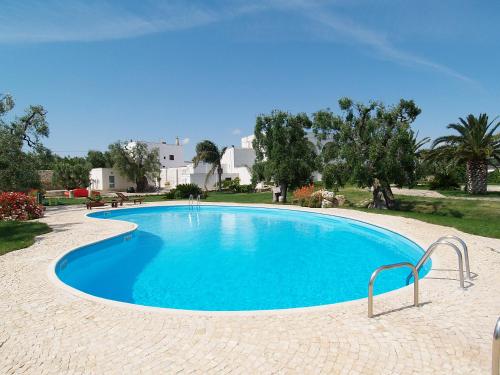 a large blue swimming pool in a resort at Hotel Masseria Tutosa in Ostuni