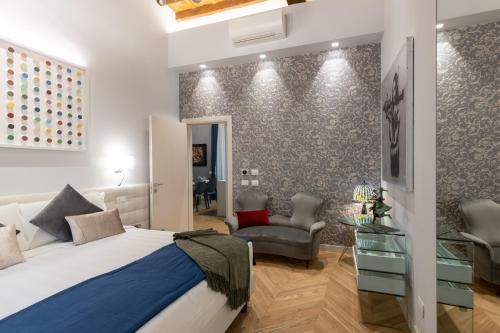 a bedroom with a bed and a desk and a chair at Kairos by Florence Art Apartments in Florence