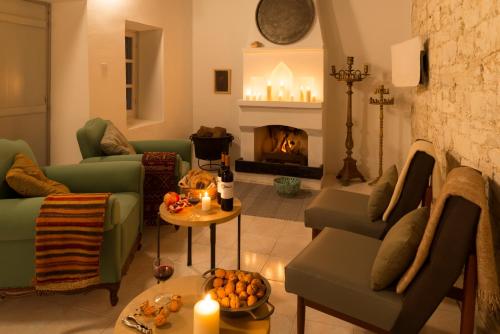 a living room with green couches and a fireplace at Ample Places in Pano Lefkara