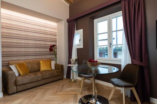a living room with a couch and a glass table at Kairos by Florence Art Apartments in Florence