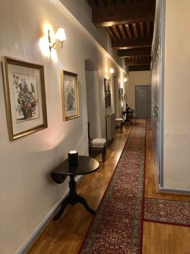 a hallway with a table and a rug at Domaine La Reveille in Dore-lʼÉglise