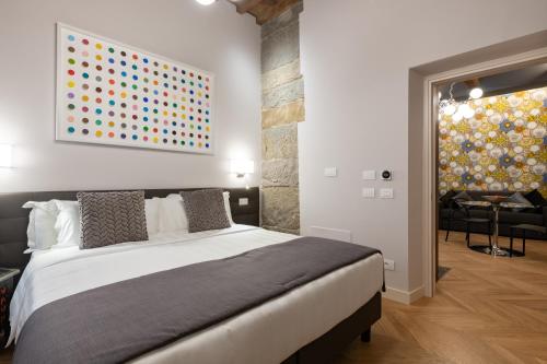 a bedroom with a bed and a painting on the wall at Kairos by Florence Art Apartments in Florence