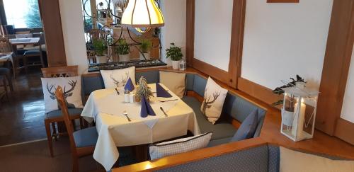 a dining room with a table and chairs at Landhaus Eickler in Baiersbronn