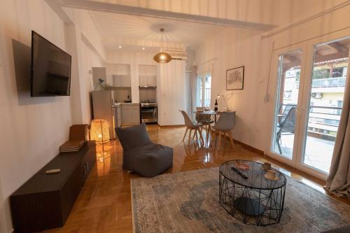 a living room with a couch and a table at Athenian Port Luxury Apartment 1/Piraeus Riviera in Piraeus