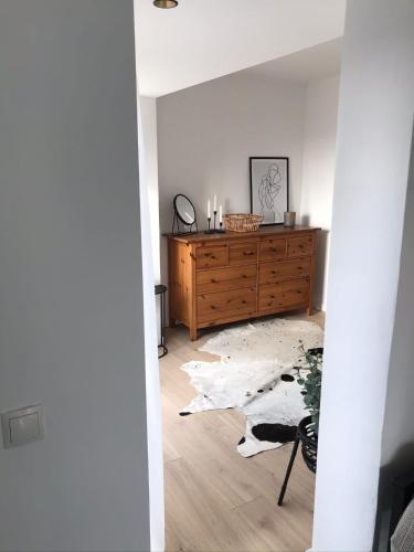 a living room with a wooden dresser at Gemütliches Bergappartement mit Weitblick in Bad Bentheim