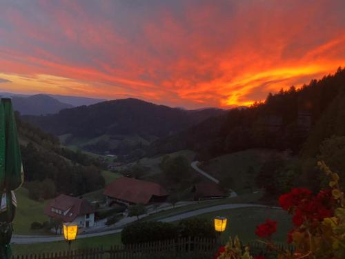 a sunset in the mountains with a red sky at Ferienhaus Wendelinus mit Pool & Sauna in Hausach
