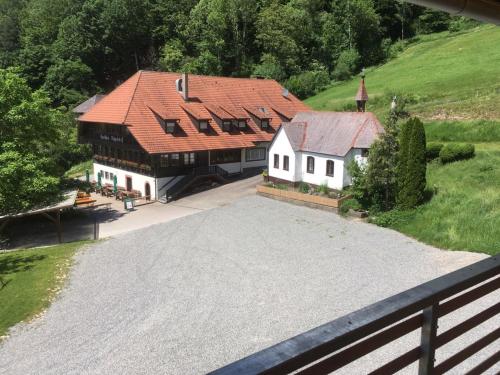an aerial view of a large house with a church at Ferienhaus Wendelinus mit Pool & Sauna in Hausach
