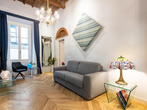 a living room with a couch and a lamp at Kairos by Florence Art Apartments in Florence