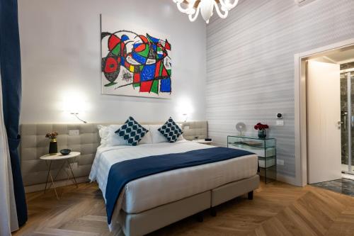 a bedroom with a bed and a painting on the wall at Kairos by Florence Art Apartments in Florence