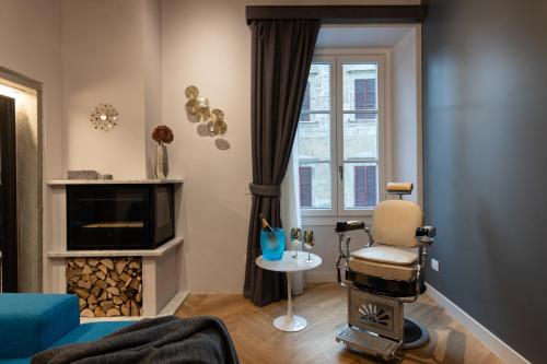 a living room with a chair and a television at Kairos by Florence Art Apartments in Florence