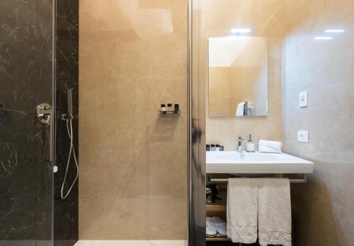 a bathroom with a sink and a shower at Kairos by Florence Art Apartments in Florence