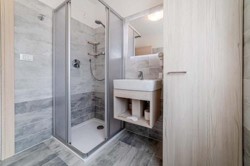 a bathroom with a sink and a shower at Ciesa Sirio in Rocca Pietore