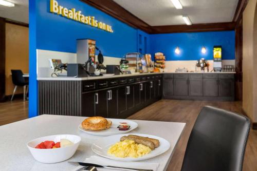 a table with two plates of breakfast food on it at Days Inn by Wyndham Fredericton in Fredericton
