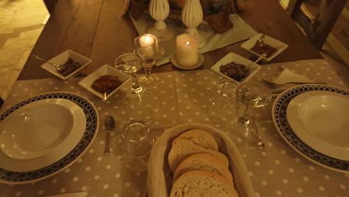 a table with two plates and glasses and food on it at Villa Dacia in Guiglia