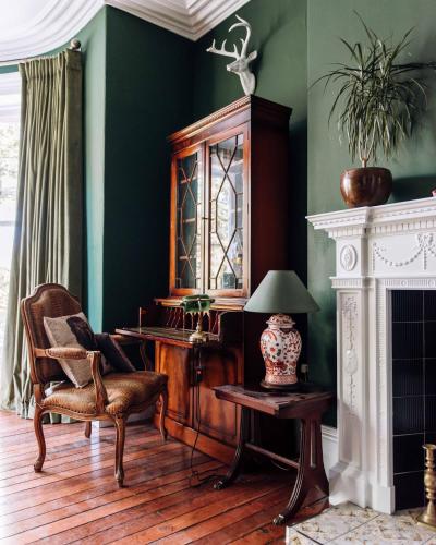 a room with a chair and a cabinet and a table at The Harrison Chambers of Distinction in Belfast