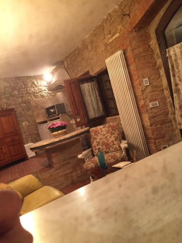 a living room with a couch and a chair in a room at Molino dei Preti in Asciano