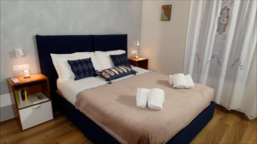1 dormitorio con 1 cama con 2 toallas en Lady Camollia Apartment, en Siena