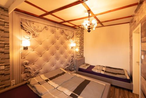 a bedroom with two beds and a chandelier at Lausitzer Seenland in Hoyerswerda