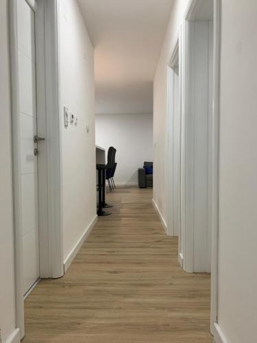 an empty hallway with white walls and wood floors at Central Аpartment Foca with garage in Foča