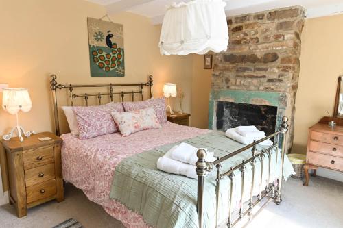 Ένα ή περισσότερα κρεβάτια σε δωμάτιο στο Mayfield Cottage