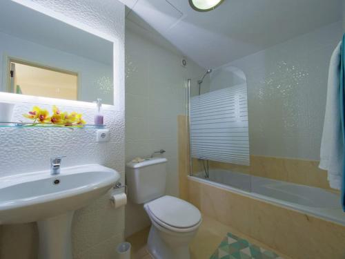 La salle de bains est pourvue de toilettes, d'un lavabo et d'une douche. dans l'établissement Apartamentos do mar, à Funchal