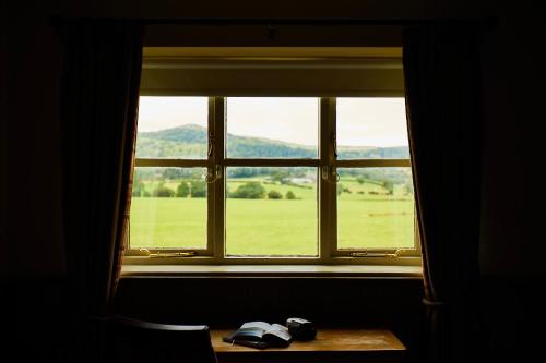 a window with a view of a field from a table at The Groes Inn in Conwy