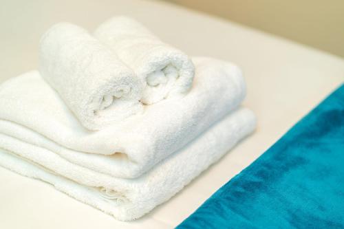 a group of white towels sitting on a table at Rosemount Residence in Aberdeen