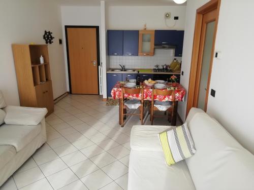 a living room with a table and a kitchen at Holiday Apartment Venice Padua Agripolis in Legnaro