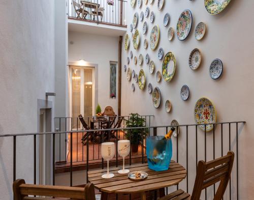 a room with a table and plates on the wall at Kairos by Florence Art Apartments in Florence