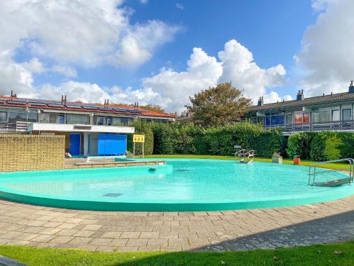 a large swimming pool in the yard of a building at Vakantieappartement Westkapelle WE07 in Westkapelle