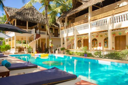 a swimming pool in front of a building at Sunbrella Boutique Hotel in Michamvi