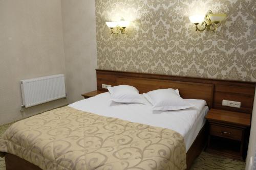 Кровать или кровати в номере Лісовий готель Гайки